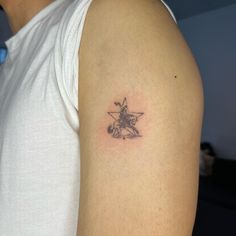 a person with a star tattoo on their arm