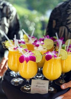 there are many glasses with drinks on the tray