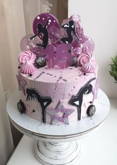 a birthday cake with pink frosting and decorations