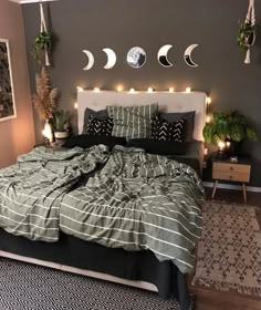 a bed room with a neatly made bed and lots of lights on the wall above it