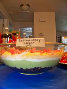 there is a bowl that has food in it on the table and some bottles behind it