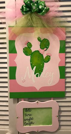 a green and pink cactus themed door hanger