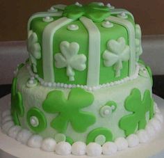 a green and white cake decorated with shamrocks