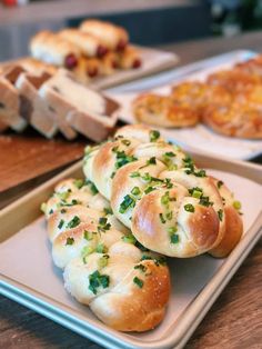 bread rolls with green onions and cheese on them