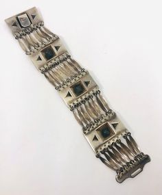 "Absolutely beautiful vintage early wide sterling silver Mexico Mayan/Aztec pyramid bracelet and earrings demi/set. Gorgeous wide panel and link bracelet with matching screw back earrings. Bracelet is signed \"Made in Mexico\" is not marked for silver content but matching earrings are and all pieces acid tested as sterling silver. Bracelet has sturdy wide hook clasp. It measures 8 inches long and 1 3/8 inches wide. The earrings are marked \"Mexico Silver\" and are 1 1/8 inches long by 5/8 inch w Vintage Oxidized Bracelet Jewelry, Handmade Modernist Metal Jewelry, Collectible Oxidized Finish Bracelet Jewelry, Adjustable Modernist Bracelet, Modernist Silver Jewelry With Oxidized Finish, Modernist Metal Bracelet Jewelry, Handmade Modernist Jewelry For Collectors, Handmade Metal Modernist Bracelets, Handmade Modernist Metal Bracelets