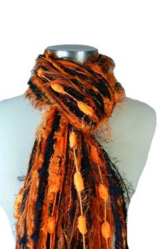 Looking for a classy way to show your Halloween Spirt? Fringe Scarves Womens Scarf - Pumpkin Patch - Shades of Orange and Black will do just the "trick"! Be a part of the latest fashion trend in unique fiber art and you saw it here first! Flora's Finest is home of the original All Fringe Knotted Scarves. A fun and funky idea I came up with to add the "WOW" factor to your wardrobe using many unique and luxurious yarns without having a heavy, knit look and feel. These scarves are fun, flirty and f Spirt Halloween, Halloween Scarf, Go Pokes, Scarf Knots, Oklahoma State University, Spooktacular Halloween, Oklahoma State, Fringe Scarf, Art Textile