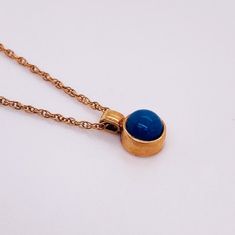 This beautiful petite pendant has a rich blue lapis lazuli dome set in rose gold! There is a wonderful pattern of sparkles amidst the deep blues of the stone that our photos can't quite capture! The rich texture of this lovely little beauty is complimented by the bright rose color of the gold pendant and petite yet sturdy rope chain. This necklace is made for the woman who wants to wear her jewelry every day! This necklace looks wonderful worn alone or stacked. Lapis lazuli is considered a birth Blue Domed Jewelry With Polished Finish, Blue Domed Cabochon Jewelry, Elegant Lapis Lazuli Oval Pendant Jewelry, Elegant Blue Cabochon Necklaces, Elegant Blue Cabochon Necklace, Elegant Blue Oval Cabochon Necklace, Elegant Lapis Lazuli Oval Cabochon Jewelry, Round Sapphire Cabochon Necklaces, Elegant Oval Cabochon Lapis Lazuli Jewelry