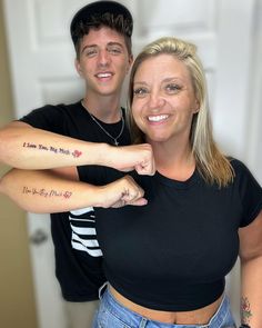 a man and woman with tattoos on their arms