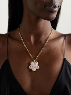 Brent Neale's necklace is clearly influenced by the "flower power" vibes of the '70s. Handmade from 18-karat gold, it has a pink opal pendant dotted with rainbow sapphires. Wear it solo or stacked with some of the brand's other playful styles. Luxury White Necklace With Flower Charm, Luxury Necklace With Flower Charm And Pendant, Luxury White Flower-shaped Necklaces, Luxury Flower Shaped Necklace, Luxury White Flower Necklace, Luxury White Flower Shaped Necklace, Luxury White Flower Shape Necklace, Luxury White Flower-shaped Necklace, Luxury Jewelry With Large Flower Pendant