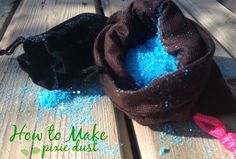 a bag filled with blue glitter sitting on top of a wooden table