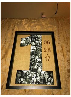 the number one made out of photos is displayed in a frame on a bed sheet