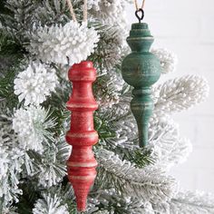 two wooden ornaments hanging from a christmas tree