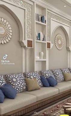 a living room filled with lots of furniture next to a wall covered in bookshelves