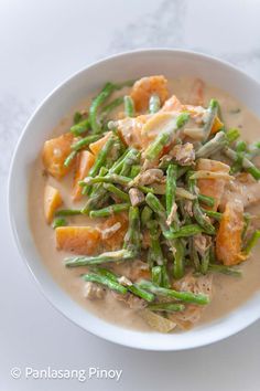 a white bowl filled with food on top of a table