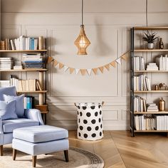 a living room with a blue chair and bookshelves on the wall next to it