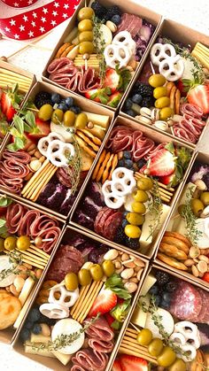 a box filled with assorted food items next to a red ribbon and an american flag