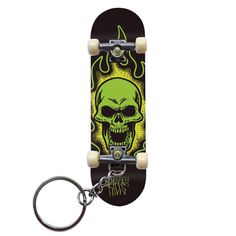 a skateboard keychain with a green skull on the front and yellow flames on the back