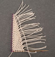 a close up of a piece of cloth with knitting needles