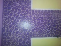 a purple wall with white circles painted on it