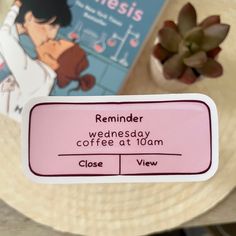 a close up of a label on a table with a plant in the background and a book