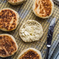 some food that is sitting on a cooling rack next to a fork and spoons