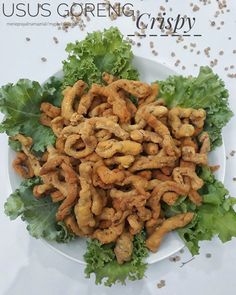 a white plate topped with fried shrimp and lettuce