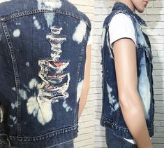 "1980's Levis denim vest. Cut off frayed sleeves with holes and bleach splashes throughout. Non-bulky fit. Dual front chest patch pockets with buttoned flaps. Perfect for adding your own patches + pins to. ✂ Measurements ✂ Labelled size: 45 Fits like: Mens 45 / Medium To Large depending on desired fit // Ladies Large ✂ Measurements: ( taken laying flat and buttoned ) Shoulders: 19.5\" Length: 24.25\" Chest: 22.5\" Waist: 21.25\" Waistband: 20.5\" Label + Fabric Levis Made in U.S.A 100% Cotton Co Tan Wool Coat, Black Satin Blouse, Medium Coat, Ruffle Neck Blouse, Bohemian Tops, Levis Denim, Sleeveless Jacket, Denim Vest, Long Blouse