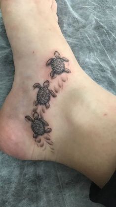 a woman's foot with two turtles on it