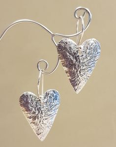 Reticulated Sterling Silver Heart Earrings with wire backs. 2.3cm in height 5.3 grams silver weight. Gift packaging available with all orders. metaluma jewellery design studios carries only quality precious metal pieces that are both handmade or imported to offer a world class selection of jewellery accessories. Customer satisfaction guaranteed. Please do not hesitate to ask if you have any questions. Materials: 925 silver, Sterling silver Gift wrapping & message available Handmade item Drop len Double Heart Metal Earrings For Gift, Silver Double Heart Earrings For Valentine's Day, Nickel-free Double Heart Earrings For Anniversary, Handmade Double Heart Sterling Silver Earrings, Metal Heart Pendant Earrings For Anniversary, Heart Charm Metal Earrings For Gift, Nickel-free Heart Pendant Earrings For Anniversary, Anniversary Heart Pendant Earrings Nickel-free, Anniversary Nickel Free Heart Pendant Earrings