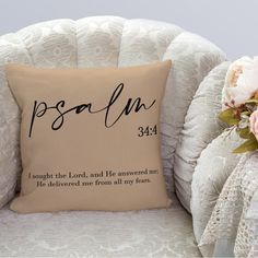 a white chair with a pillow on it and flowers in front of the cushion that says, i thought the lord and he answered