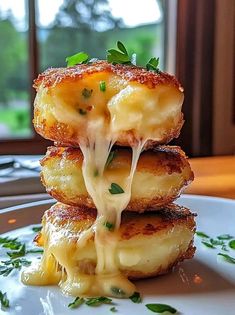 three pieces of food stacked on top of each other with cheese and parmesan