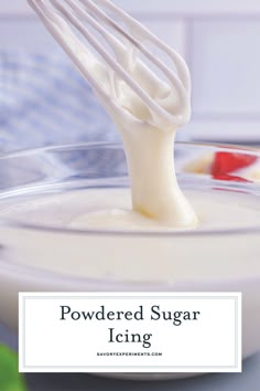 a whisk is being used to make powdered sugar icing in a bowl