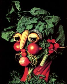 a head made out of vegetables on top of green leaves