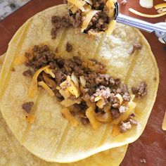 three tortillas with meat and cheese on them