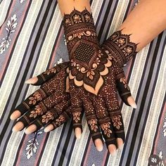 a woman's hands with hennap on top of her arm and hand