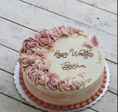 a birthday cake with pink frosting and flowers on it that says happy mother's day