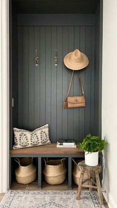 a bench with two baskets and a hat on it in front of a wooden wall