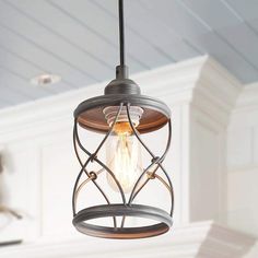 a light fixture hanging from the ceiling in a room with white walls and wood paneling