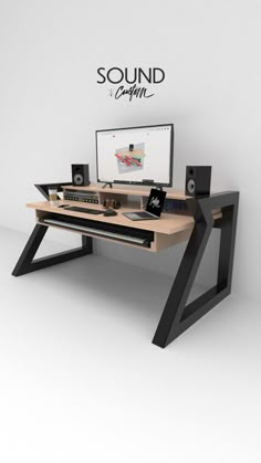 a computer desk with speakers and a monitor on it's side, in front of a white wall