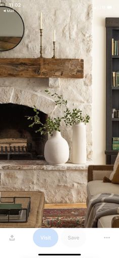 a living room filled with furniture and a fire place in front of a stone fireplace