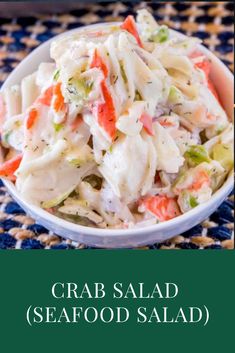 crab salad in a white bowl on top of a blue and green placemat with the words crab salad seafood salad