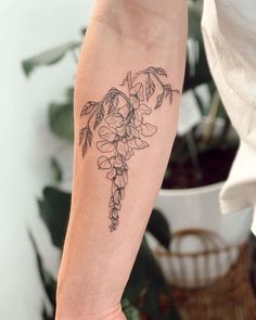 a woman's arm with a flower tattoo on it