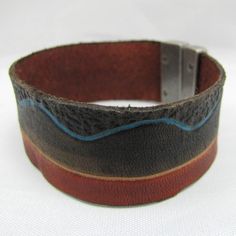 "The South Scape leather Bracelet/Cuff is made of tooled thick leather. It will be hand tooled, carved, painted, and dyed. The metal clasp locks in place with the T-bar that slips in the groove. A waterproofing leather conditioner will be applied to the Bracelet/Cuff to beautify, condition, and strengthen the leather so it will hold up for a lifetime of use. Measurements: Total Length-?you decide - for example the one in the photo is 8 1/4\" (21cm) With-1\" (2.5cm) I can adjust this bracelet to Adjustable Hand Tooled Leather Cuff Bracelet, Southwestern Hand Tooled Leather Bracelets, Adjustable Stamped Leather Cuff Bracelet, Adjustable Stamped Leather Bracelet, Southwestern Adjustable Leather Cuff Bracelet, Adjustable Southwestern Leather Cuff Bracelet, Southwestern Brown Leather Cuff Bracelet, Brown Stamped Cuff Bracelets, Brown Stamped Cuff Bracelet