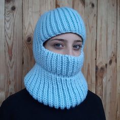 a woman wearing a blue knitted ski mask