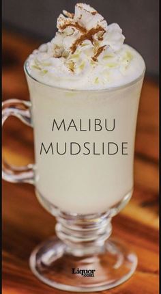 a close up of a drink in a glass on a table with the words malbu mudslide