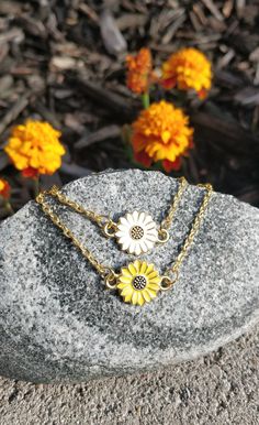 "This bracelet is perfect for anyone! You can choose a yellow sunflower or a white daisy. The metal is a gold color. The flower measures 1/2\" wide. The bracelet has an extender on it so it is adjustable, and it has a heart charm at the end. Perfect for a Mom gift, for a Christmas gift, anniversary, or a birthday. All jewelry items come in a gift box." White Flower Charm Jewelry For Friendship, Gold Bracelets With Flower Shape For Mother's Day, White Jewelry With Flower Charm For Friendship, Gold Flower-shaped Bracelets For Mother's Day, Gold Flower-shaped Bracelet For Mother's Day, Cute Gold Jewelry For Bridesmaids, Gold Bracelet With Birth Flower For Gift, Dainty Yellow Bracelet For Gift, Dainty Yellow Bracelet As Gift