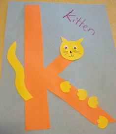 the letter k is made up of paper and cut out to look like a cat