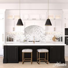 a kitchen with white cabinets and black counter tops, two stools in front of the sink