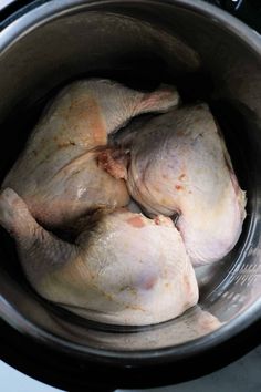 two chickens are in an instant pot on the stove top, ready to be cooked