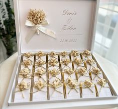 a box filled with lots of gold flowers on top of a white tablecloth covered table